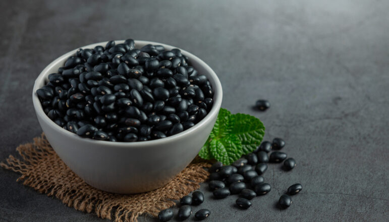 black beans in white small bowl place on dark floor black beans in white small bowl place on dark floor